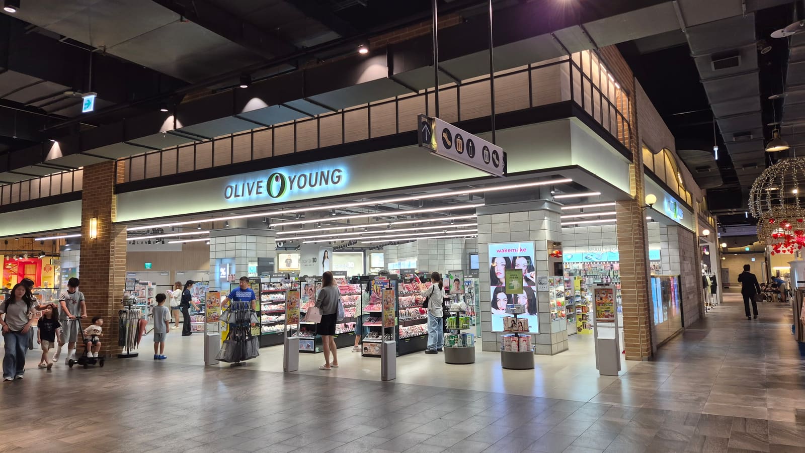 Olive Young runs 151 stores in global tourist districts, and its own survey found visitors going to 2.8 of them on average.